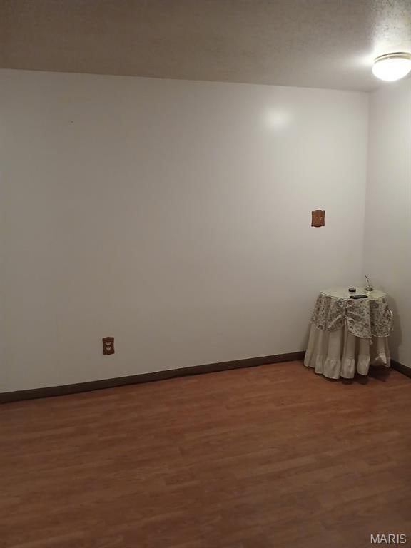 10506 Camden Park Dr, Saint Louis, MO 63135 - spare room featuring wood finished floors and baseboards