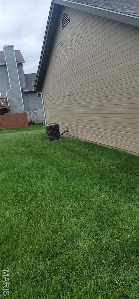 10506 Camden Park Dr, Saint Louis, MO 63135 - view of home's exterior with a lawn and central air condition unit