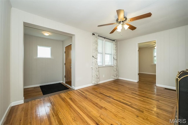 126 E Waymire Ave, Saint Louis, MO 63119 - unfurnished living room featuring light wood-style flooring, a ceiling fan, and healthy amount of natural light