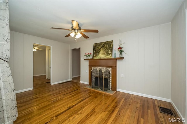 126 E Waymire Ave, Saint Louis, MO 63119 - unfurnished living room with a ceiling fan, a tile fireplace, wood finished floors, and baseboards