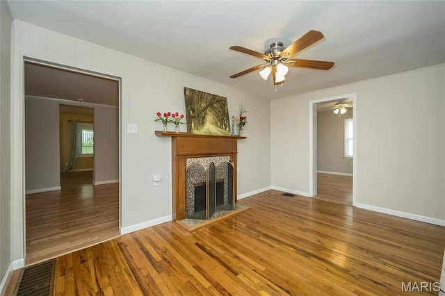 126 E Waymire Ave, Saint Louis, MO 63119 - unfurnished living room with a tile fireplace, ceiling fan, wood finished floors, and baseboards