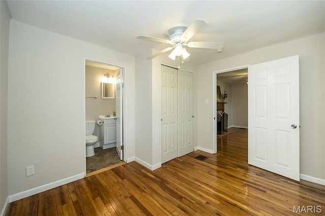 126 E Waymire Ave, Saint Louis, MO 63119 - unfurnished bedroom with hardwood / wood-style floors, a closet, baseboards, ensuite bathroom, and a ceiling fan