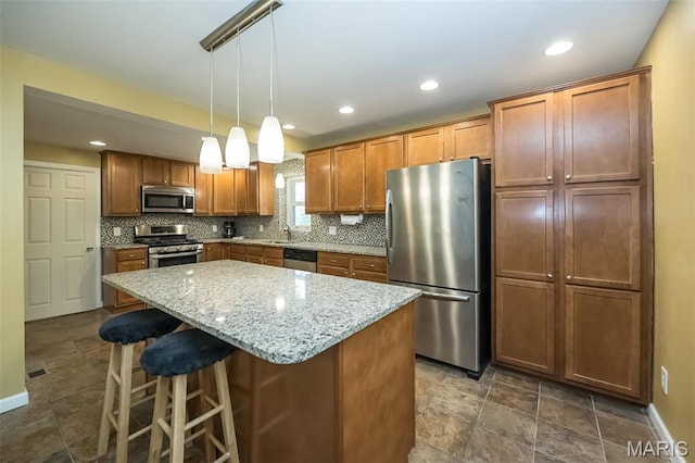 126 E Waymire Ave, Saint Louis, MO 63119 - kitchen with appliances with stainless steel finishes, decorative backsplash, a center island, a breakfast bar, and a sink