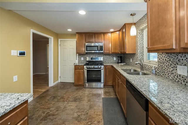 126 E Waymire Ave, Saint Louis, MO 63119 - kitchen featuring appliances with stainless steel finishes, a sink, decorative backsplash, brown cabinets, and recessed lighting