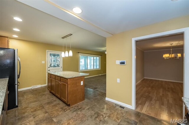 126 E Waymire Ave, Saint Louis, MO 63119 - kitchen with freestanding refrigerator, brown cabinetry, a chandelier, baseboards, and pendant lighting