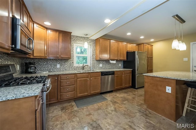 126 E Waymire Ave, Saint Louis, MO 63119 - kitchen featuring appliances with stainless steel finishes, a sink, tasteful backsplash, brown cabinetry, and light stone countertops