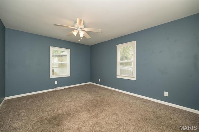 126 E Waymire Ave, Saint Louis, MO 63119 - unfurnished room featuring plenty of natural light, a ceiling fan, carpet flooring, and baseboards