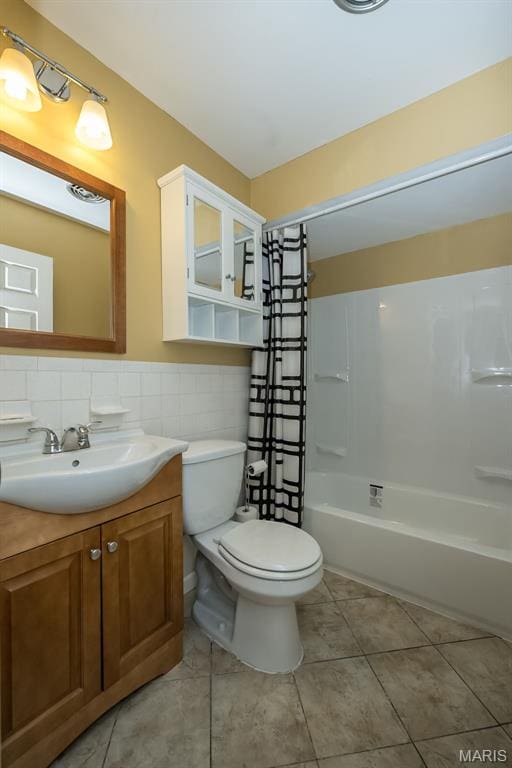 126 E Waymire Ave, Saint Louis, MO 63119 - bathroom featuring toilet, vanity, tile patterned flooring, shower / tub combination, and tile walls
