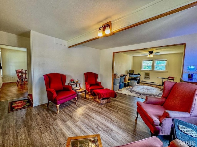 274 Cornelison St, Lebanon, MO 65536 - living room with wood finished floors, a baseboard radiator, a textured ceiling, a ceiling fan, and baseboards