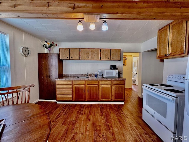 274 Cornelison St, Lebanon, MO 65536 - kitchen with white appliances, a sink, brown cabinetry, and dark wood finished floors