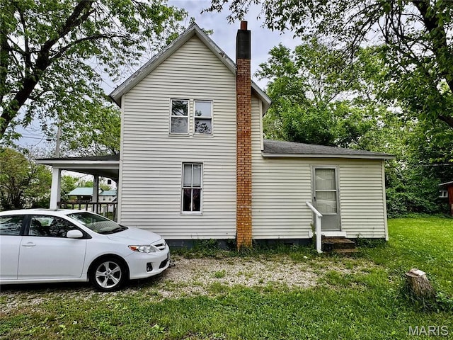 274 Cornelison St, Lebanon, MO 65536 - view of home's exterior with a lawn and a chimney
