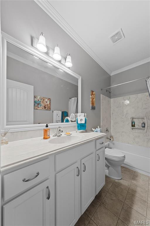 full bathroom featuring crown molding, vanity, toilet, shower / bath combination, and tile patterned flooring