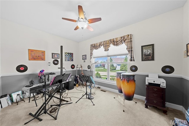 rec room featuring carpet flooring, a ceiling fan, and baseboards