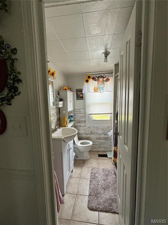 1921 W W Springfield Rd, Saint Clair, MO 63077 - bathroom with tile patterned floors, vanity, toilet, tile walls, and a drop ceiling