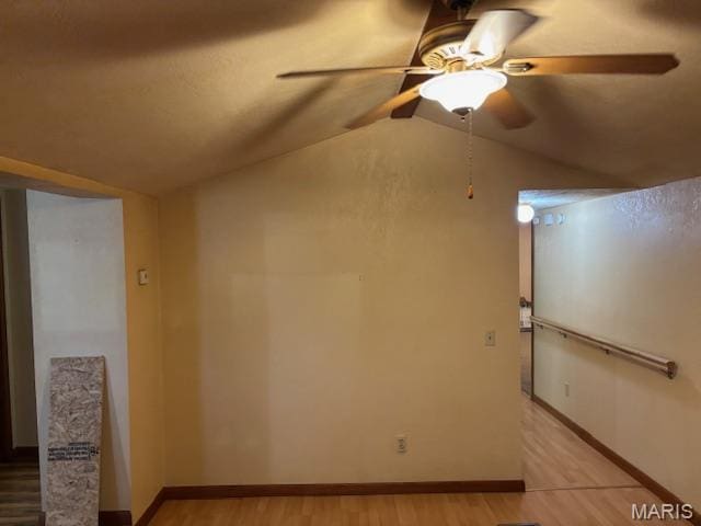 unfurnished room featuring lofted ceiling, light wood-type flooring, and ceiling fan