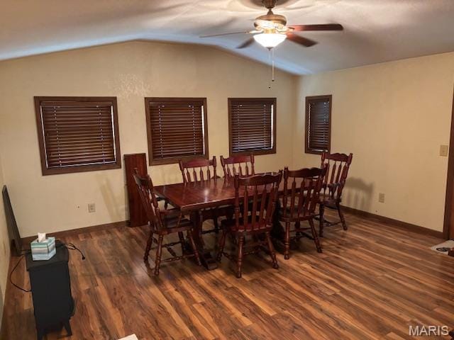 dining space with vaulted ceiling, wood finished floors, ceiling fan, and baseboards