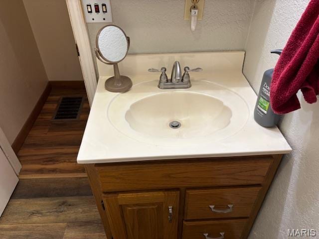 bathroom featuring vanity and wood finished floors