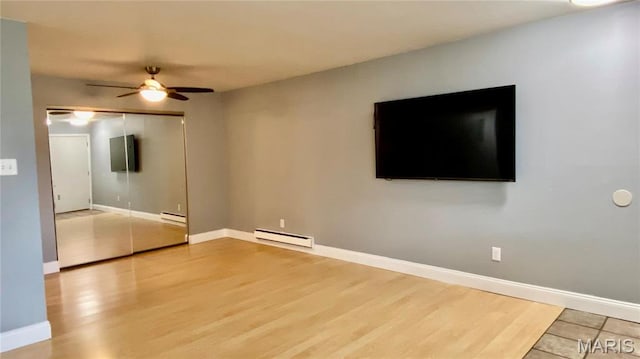 unfurnished living room featuring a baseboard radiator, ceiling fan, wood finished floors, and baseboards