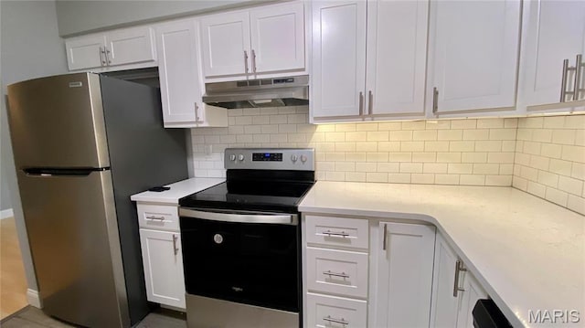 kitchen with under cabinet range hood, stainless steel appliances, light countertops, white cabinets, and tasteful backsplash