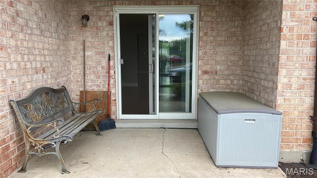 view of exterior entry with brick siding