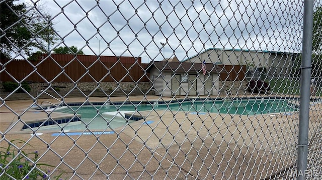 view of pool featuring fence