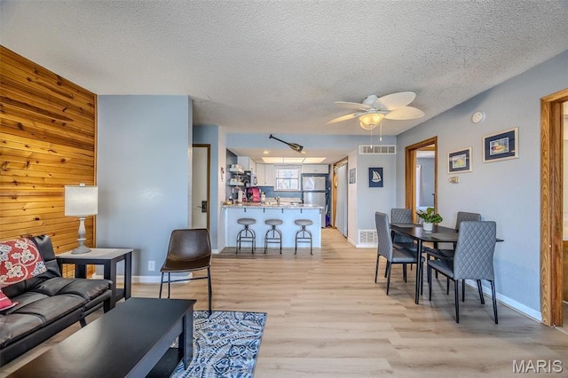 256 Lone Oak Unit 15, Sunrise Beach, MO 65079 - living area featuring light wood-type flooring, ceiling fan, a textured ceiling, and baseboards
