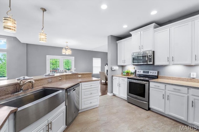 2226 Bay Tree Dr, Saint Peters, MO 63376 - kitchen with stainless steel appliances, a sink, healthy amount of natural light, white cabinets, and recessed lighting