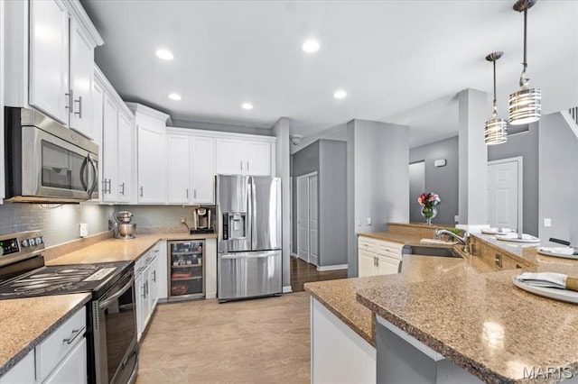 2226 Bay Tree Dr, Saint Peters, MO 63376 - kitchen featuring stainless steel appliances, wine cooler, recessed lighting, white cabinetry, and a sink
