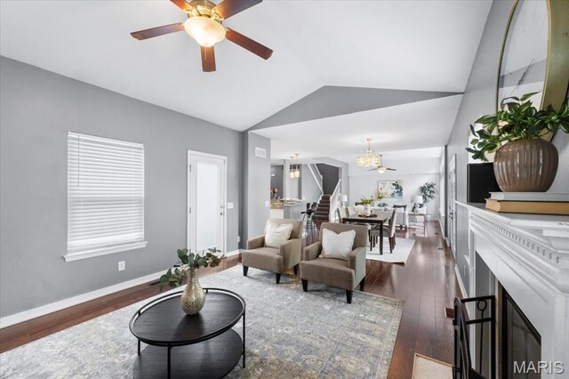2226 Bay Tree Dr, Saint Peters, MO 63376 - living area with vaulted ceiling, a ceiling fan, dark wood finished floors, baseboards, and a fireplace with flush hearth