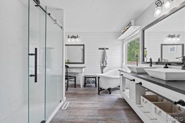 2226 Bay Tree Dr, Saint Peters, MO 63376 - bathroom featuring a stall shower, wood finished floors, a freestanding tub, and vanity