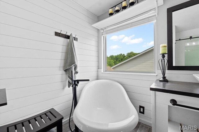 2226 Bay Tree Dr, Saint Peters, MO 63376 - bathroom featuring wooden walls, a soaking tub, wood finished floors, and vanity