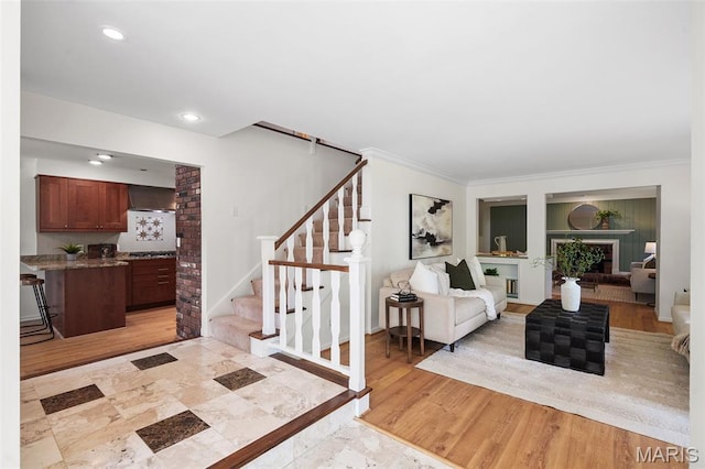 2125 Crystal Dr, Saint Louis, MO 63131 - living area with stairs, crown molding, recessed lighting, light wood-style flooring, and built in shelves