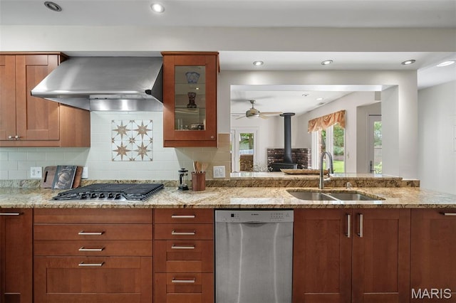2125 Crystal Dr, Saint Louis, MO 63131 - kitchen with appliances with stainless steel finishes, wall chimney range hood, a sink, light stone countertops, and backsplash