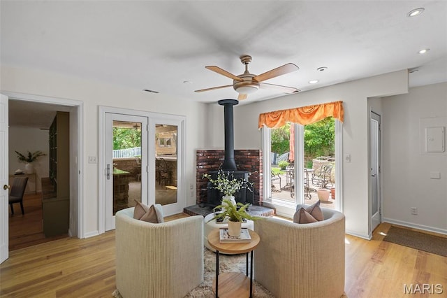 2125 Crystal Dr, Saint Louis, MO 63131 - living area with ceiling fan, light wood-type flooring, a wood stove, baseboards, and recessed lighting