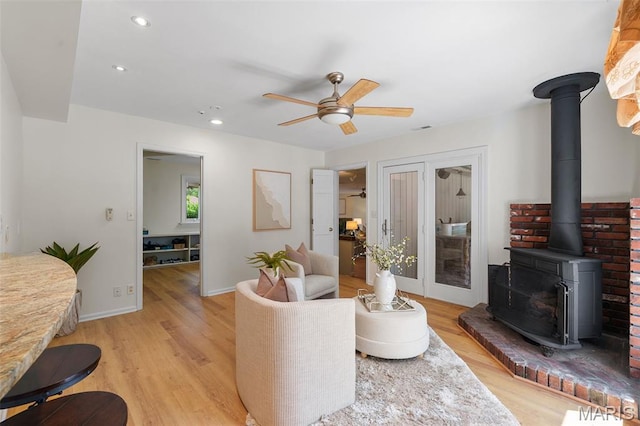 2125 Crystal Dr, Saint Louis, MO 63131 - living area featuring a wood stove, ceiling fan, light wood-style floors, recessed lighting, and baseboards