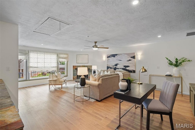 2125 Crystal Dr, Saint Louis, MO 63131 - living area featuring a textured ceiling, a ceiling fan, light wood-style flooring, attic access, and recessed lighting
