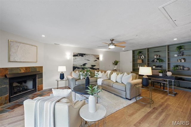2125 Crystal Dr, Saint Louis, MO 63131 - living area with wood finished floors, ceiling fan, a tile fireplace, recessed lighting, and attic access