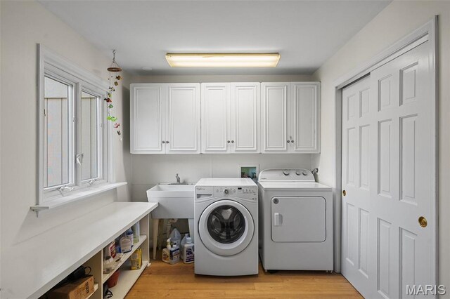 2125 Crystal Dr, Saint Louis, MO 63131 - laundry area featuring cabinet space, independent washer and dryer, and light wood-style flooring