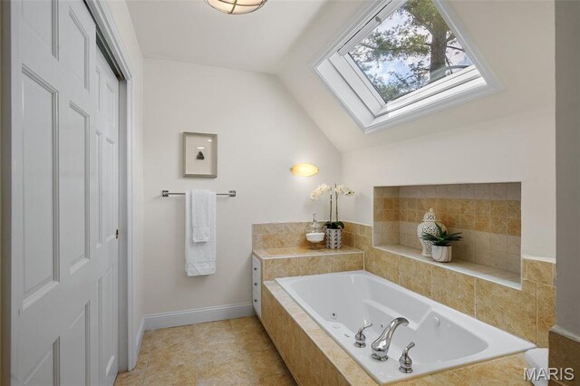 2125 Crystal Dr, Saint Louis, MO 63131 - full bathroom featuring a tub with jets, lofted ceiling, a skylight, and baseboards