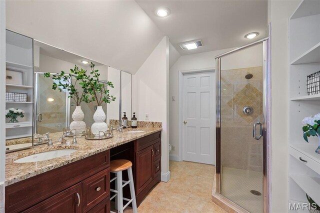 2125 Crystal Dr, Saint Louis, MO 63131 - bathroom featuring double vanity, a stall shower, vaulted ceiling, toilet, and tile patterned floors