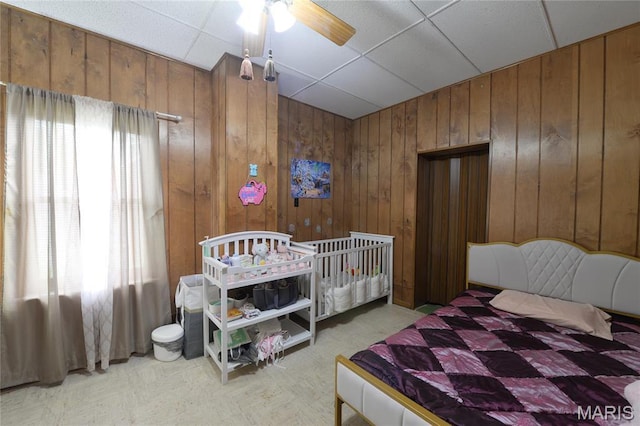 bedroom featuring wood walls