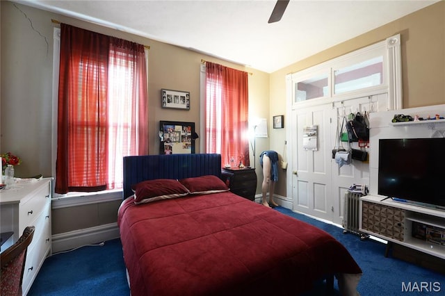 carpeted bedroom featuring a ceiling fan and baseboards