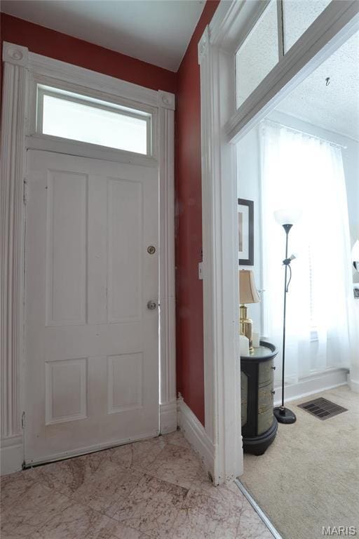 foyer featuring baseboards