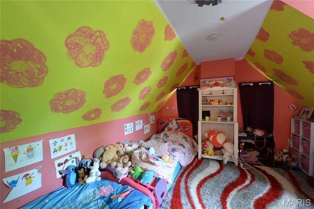 bedroom featuring lofted ceiling and carpet floors