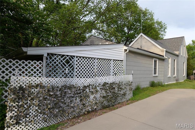 view of property exterior featuring a shingled roof