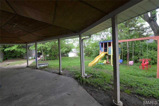 view of patio / terrace with a playground, a storage shed, and an outbuilding