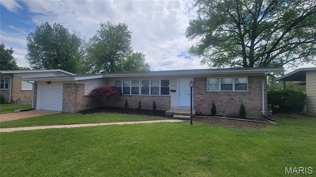 2490 Northridge Pl, Florissant, MO 63033 - ranch-style home with brick siding, a garage, a front yard, and driveway