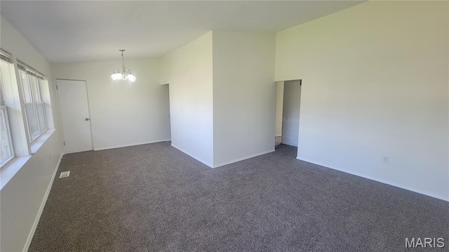 2490 Northridge Pl, Florissant, MO 63033 - spare room featuring a chandelier, dark colored carpet, and baseboards