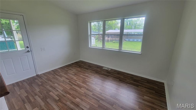 2490 Northridge Pl, Florissant, MO 63033 - spare room with healthy amount of natural light, wood finished floors, and baseboards