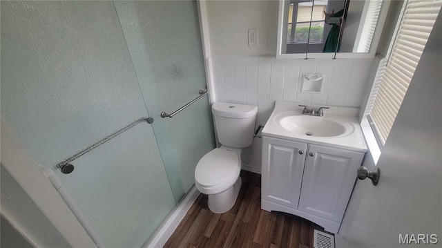 2490 Northridge Pl, Florissant, MO 63033 - bathroom with a stall shower, wood finished floors, toilet, vanity, and tile walls